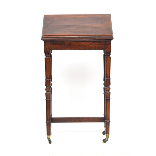 544 - A late Regency rosewood reading table, hinged reading slope, on turned supports, with brass caps and... 