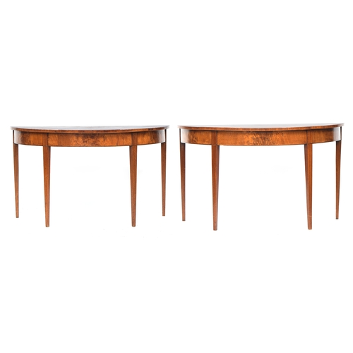 585 - A pair of George III mahogany demilune tables, the tops with radiating veneers, on plain square tape... 