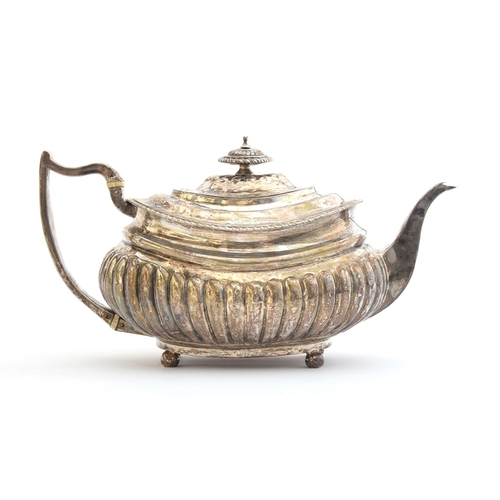 68 - A George III silver teapot by Solomon Hougham, London 1815, with part fluted body, the scroll handle... 