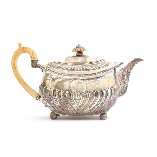 69 - A George III silver teapot by Thomas Robins, London 1814, of rectangular form with half gadrooned bo... 