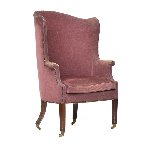 607 - An early 20th century barrel back armchair, with squab cushion, on square tapered front legs with br... 