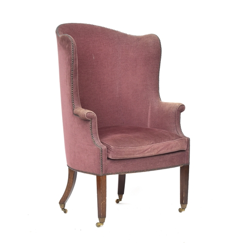 607 - An early 20th century barrel back armchair, with squab cushion, on square tapered front legs with br... 