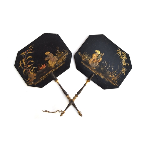 115 - A pair of 19th century black lacquered papier mache face screens, each painted with chinoiserie scen... 