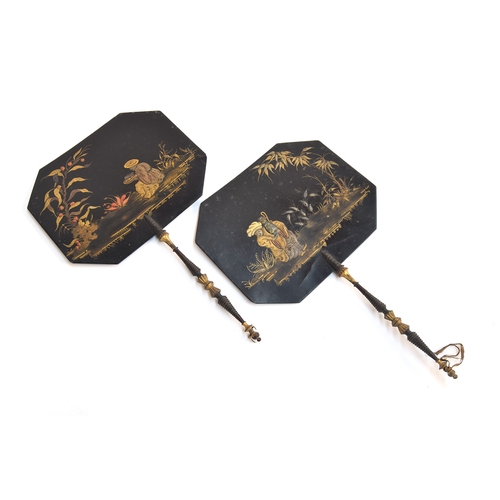 115 - A pair of 19th century black lacquered papier mache face screens, each painted with chinoiserie scen... 