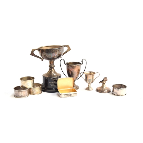 64 - A mixed lot of various silver items, to include several twin handled trophy cups, four napkin rings,... 