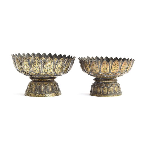 153 - Two 19th century Thai niello gilded silver footed bowls of lotus form, each with petal shaped rims o... 