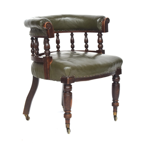 609 - A 19th century green leather upholstered captain's chair, on turned front legs and brass casters, 69... 