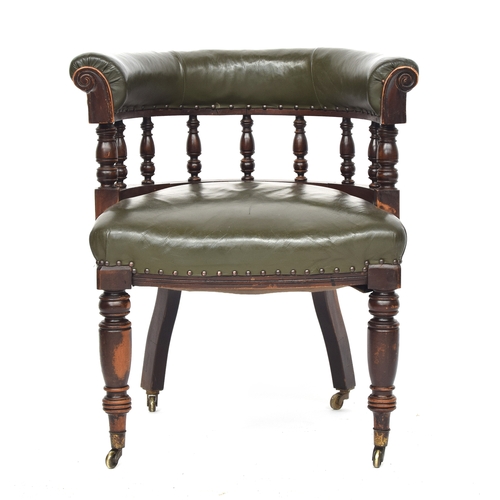 609 - A 19th century green leather upholstered captain's chair, on turned front legs and brass casters, 69... 