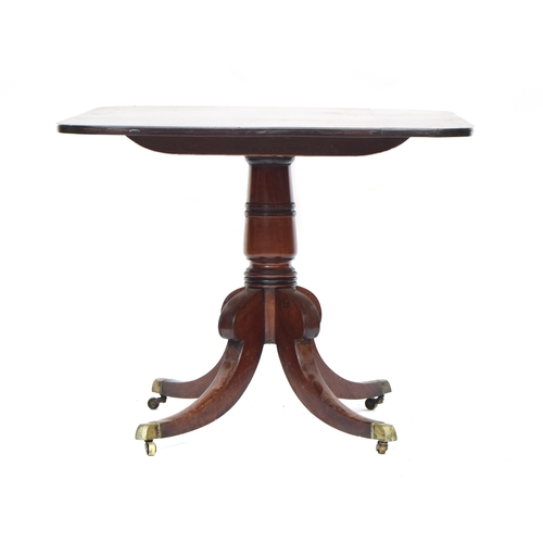 568 - A Regency mahogany dining table, the rectangular tip top raised on a turned column and four swept le... 