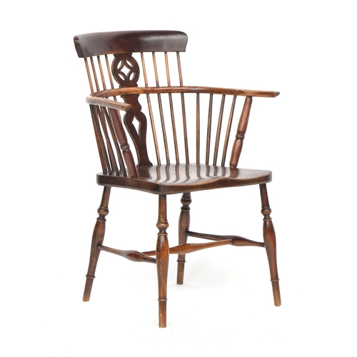 627 - A 19th century ash and elm comb back Windsor armchair, the curved top rail over a pierced splat, the... 