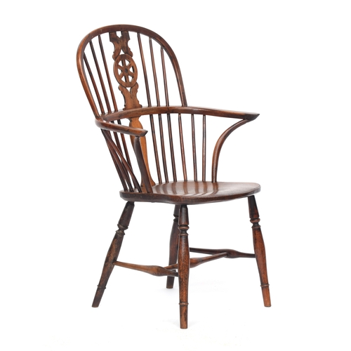 628 - A 19th century yew and elm wheelback Windsor chair, wide set arms on bent front supports, on ring an... 