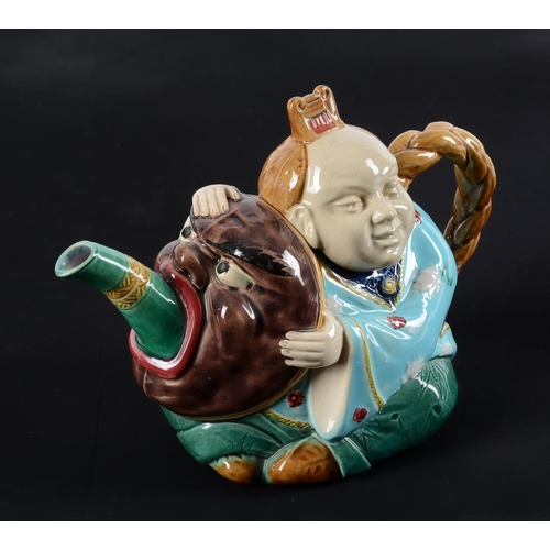 197 - A Minton majolica teapot and cover modelled as a Chinese figure, date code for 1874, faintly impress... 