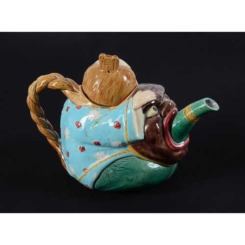 197 - A Minton majolica teapot and cover modelled as a Chinese figure, date code for 1874, faintly impress... 