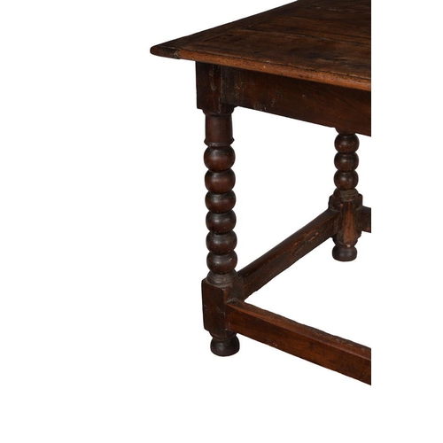 464 - An early 18th century oak side table, the rectangular top above bobbin-turned legs, 131cm wide, 71cm... 