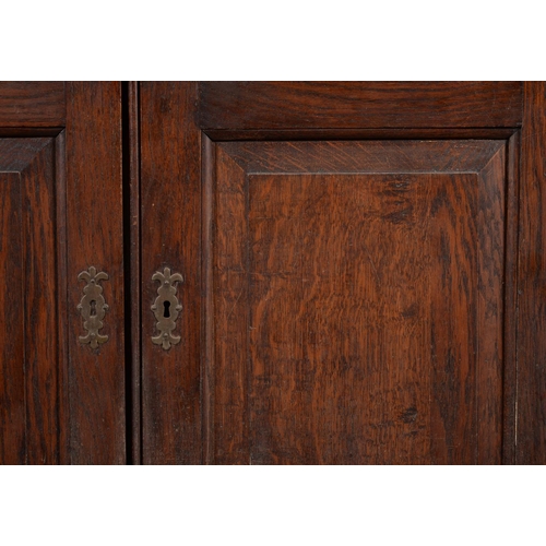 462 - A George III oak dwarf press cupboard, c.1780, the rectangular top with moulded edge above a pair of... 