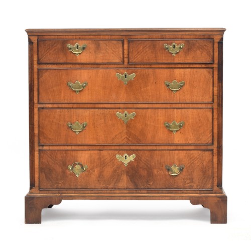 488 - A George III walnut chest of drawers, the three quarter veneer top over two short and three graduati... 