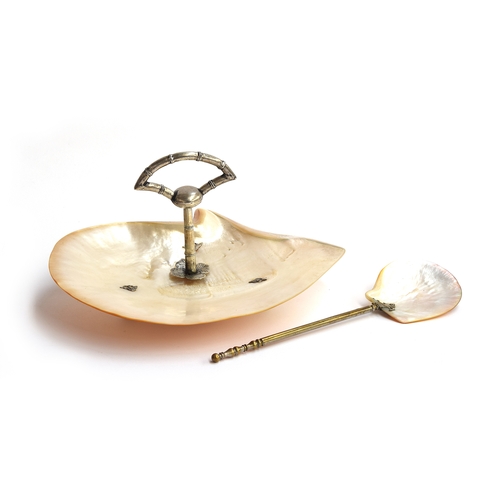 94 - A mother of pearl shell caviar dish and serving spoon, with white metal bamboo form handle, on three... 