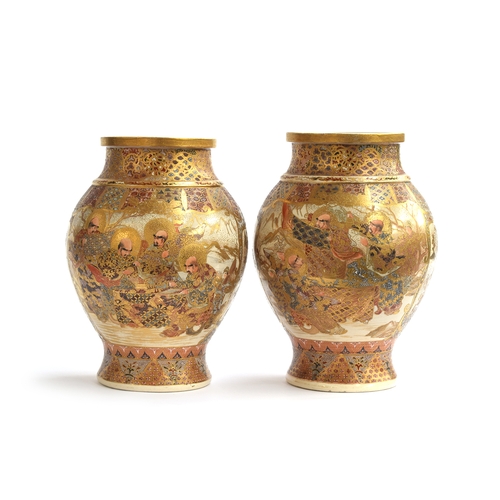 121 - A pair of Meiji period Japanese Satsuma vases, of baluster form, decorated with immortals and panels... 