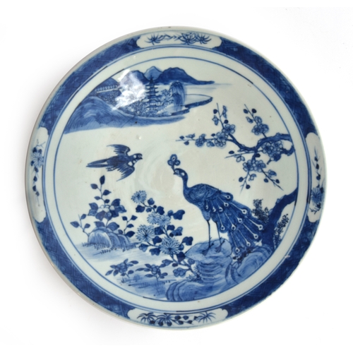 150 - A Chinese export blue and white porcelain charger, decorated with a scene of a peacock and sparrow a... 