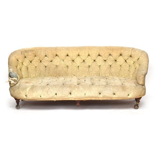 601 - A Victorian button back sofa, probably Howard & Sons, on turned legs and Cope & Collinson brass caps... 