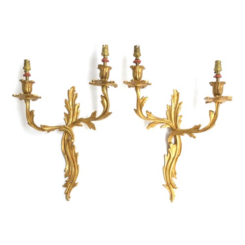 377 - A pair of gilt metal wall sconces of foliate form, 48cm high

Provenance: Formerly part of the origi... 