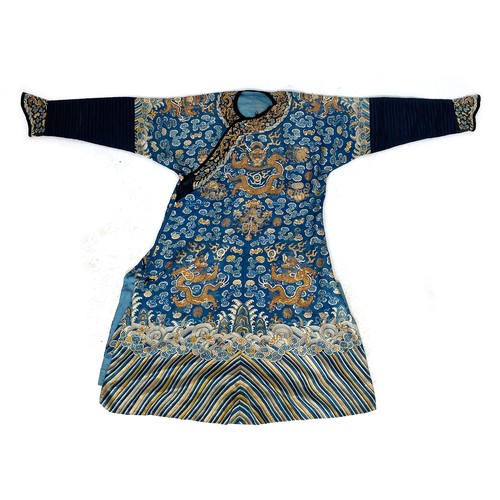 653 - A 19th century Chinese blue silk 'dragon' robe with long sleeves and horse hoof cuffs, detailed with... 