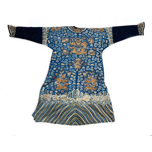 653 - A 19th century Chinese blue silk 'dragon' robe with long sleeves and horse hoof cuffs, detailed with... 