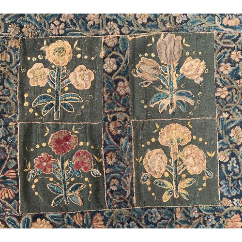 652 - A 17th century needlework tapestry table carpet, ten floral needlework slips depicting tulips, daffo... 