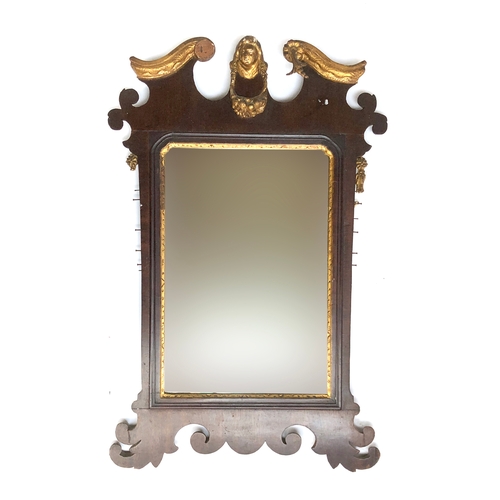 395 - An 18th century fret carved wall mirror, with gilt carved bust of a lady cresting, a swag of fruit b... 