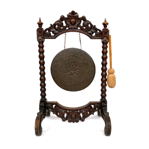 649 - A late 19th/early 20th century carved country house gong, 63cm wide, 107cm high

Provenance: the Pet... 