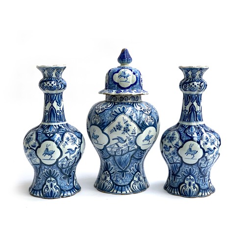 201 - A pair of late 18th/early 19th century Delft vases of lobed tapering form, with alternating hand pai... 