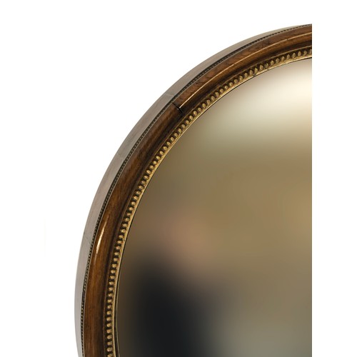 386 - A 19th century oval wall mirror, in a deep walnut frame, with gilt bobble moulded slip, 66cm wide, 7... 