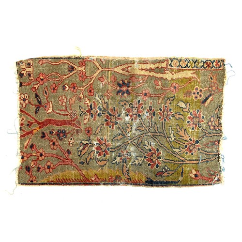 655 - An early carpet fragment depicting flora on a yellow ground, 44x72cm