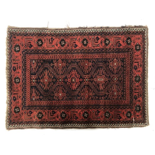 666 - A small rug, red ground with three serrated lozenges, 107x146cm