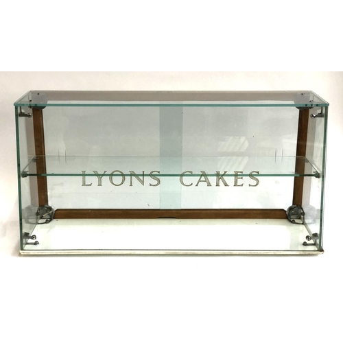 304 - A vintage Lyons Cakes glass display cabinet with sliding doors and single shelf, ceramic base, 76cmW