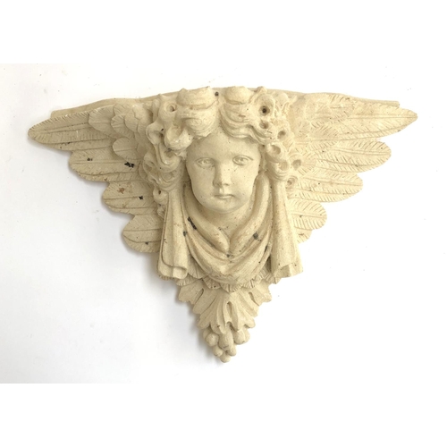 306 - A cast stone wall bracket in the form of a putti, 31cmH 46cmW