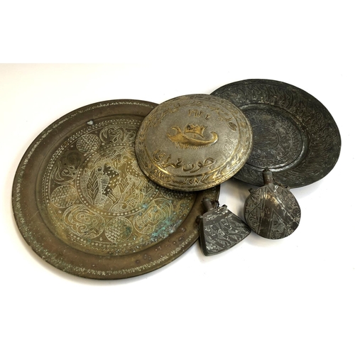 316 - Two worked Islamic metal trays, 49cmW and 36cmW; together with a similar plaque and two flasks