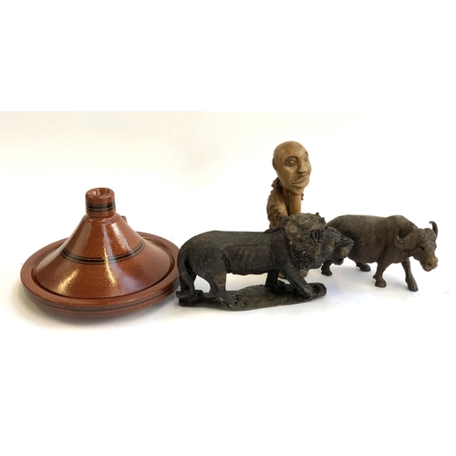 321 - A carved hardwood lion; carved hardwood buffalo; Moroccan tagine etc