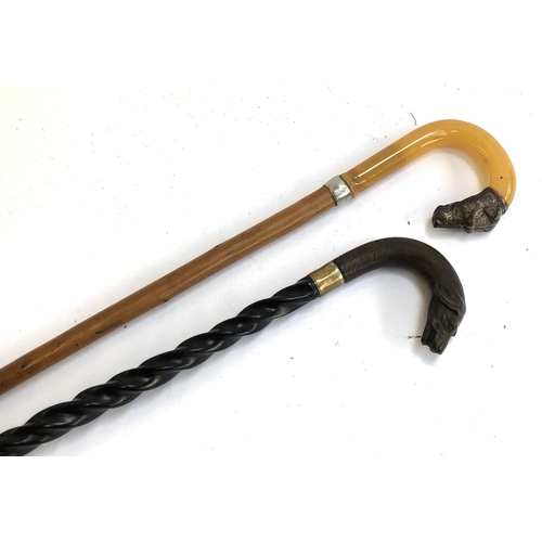 322 - A spiral turned walking stick with hound terminal; together with one other with faux horn and hound ... 