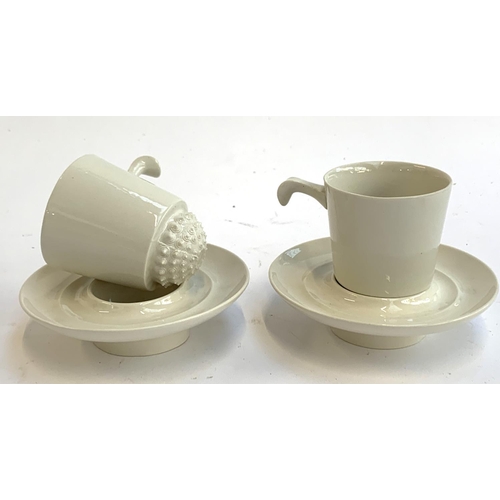 157 - A pair of unusual ceramic coffee cups and saucers with rounded spiked bases