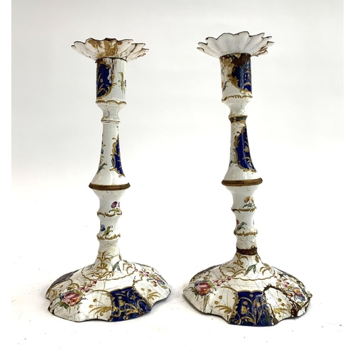 160 - A pair of 18th century South Staffordshire, likely Bilston, enamel candlesticks (af), decorated in b... 