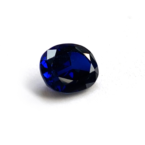 35 - An unmounted inky blue oval cut sapphire, 1x0.8x0.5, 0.75g, approx. 3ct