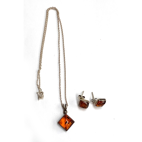 9 - A silver and amber necklace; together with a pair of matching stud earrings