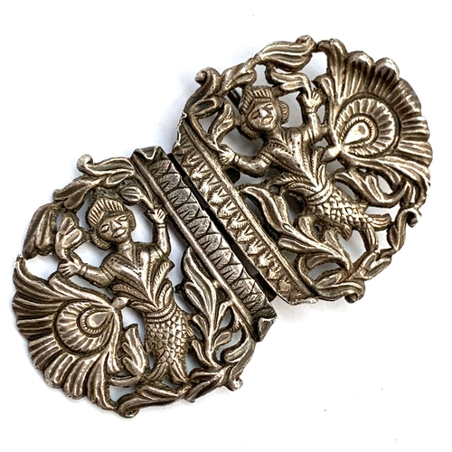 37 - An unusual Eastern white metal buckle, of pierced form depicting mermaids and peacock feathers, 9.5c... 