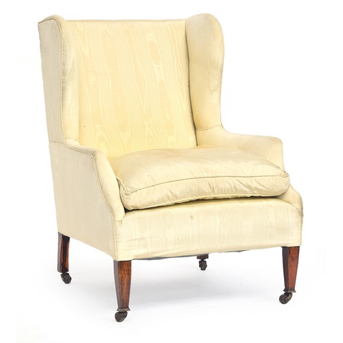 605 - A good wingback armchair, upholstered in watered silk, on square tapered legs with brass caps and ca... 