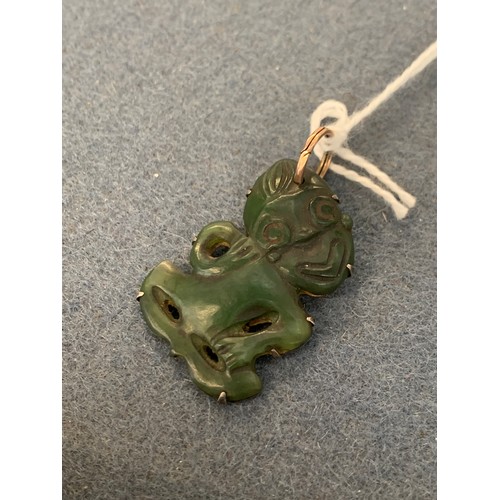 39 - A 19th century Maori Hei Tiki pounamu nephrite pendant, four overall perforations, well carved with ... 