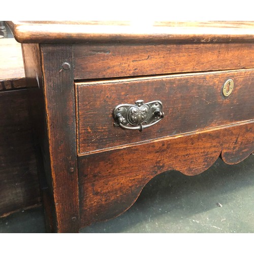 506 - An 18th century oak dresser base, three drawers over a shaped apron, on chamfered square section leg... 