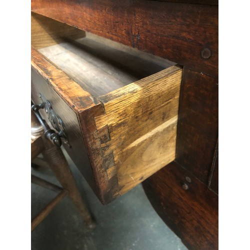 506 - An 18th century oak dresser base, three drawers over a shaped apron, on chamfered square section leg... 