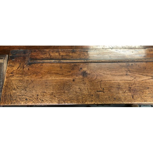 506 - An 18th century oak dresser base, three drawers over a shaped apron, on chamfered square section leg... 