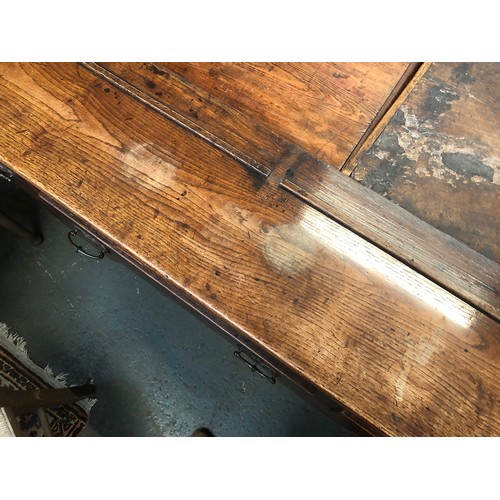 506 - An 18th century oak dresser base, three drawers over a shaped apron, on chamfered square section leg... 